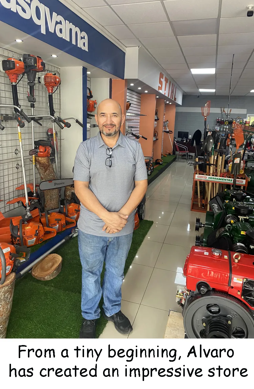 Alvaro standing in his lawn-equipment store among chainsaws and trimmers.