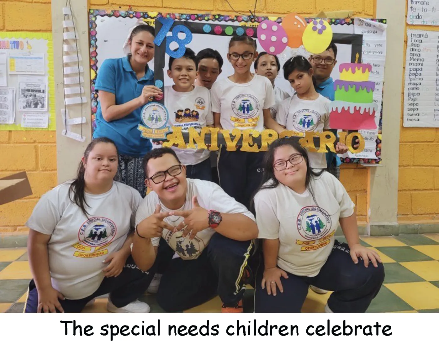 Students and a teacher celebrating an anniversary at the special-needs school.